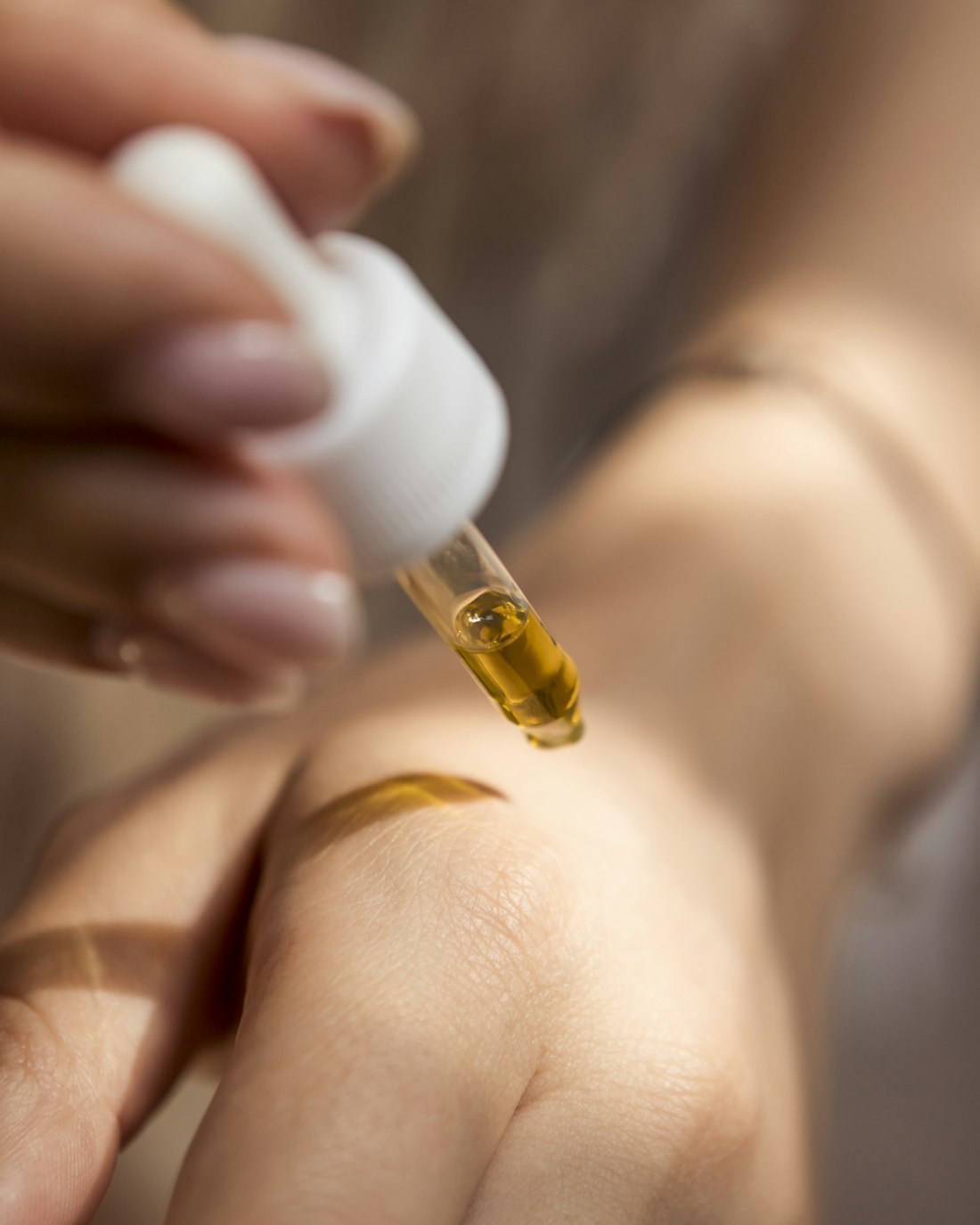 A gold skincare serum applied during a med-spa treatment